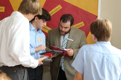 Mr. Graham Otton '05 assists students in Canvas, Chaminade's new Learning Management System, on their iPads.