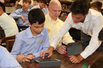A Senior Leader helps a new freshman with his iPad during 3-C Week.