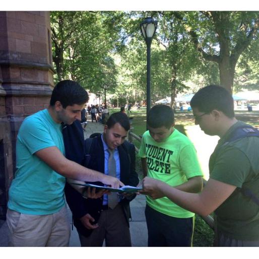 Teammates help John Michael prepare for his semi-final round. 