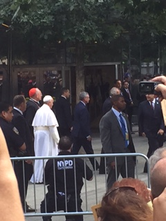 Pope Francis is escorted by his security team and the NYPD