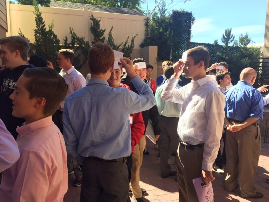 Breaking the ice, students play “Heads Up!” a twist on the popular cell phone app. 