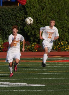 Tim Davis ’17 and James Donnelly ’16 chase a stray ball.