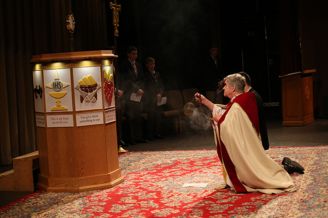 School chaplain, Father Garrett Long S.M. '62, spreads incense in front of the Eucharist at the Sodality Prayer Service.