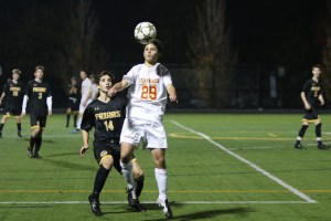 Heads up! Jack Graziano '17 gives his legs a break while protecting possession of the ball.