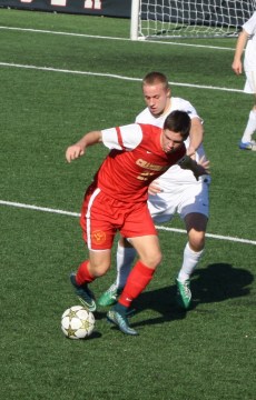 Junior Matt Vowinkel battles with a Crusader defender as he attempts to get the offense going.