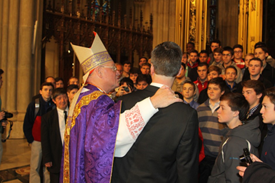 Cardinal Dolan, with his arm around Bro. Peter S.M. ’86, speaks to the Chaminade pilgrims before a group photo. 