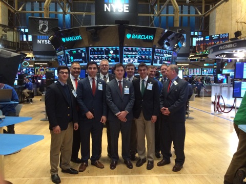 The select members of the Economics Club pose with a few traders and analysts on the floor of the New York Stock Exchange.
