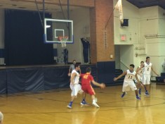 Tim Phillips ’17 mid-dribble drives to the hoop.