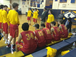 The team stands for the pre-game announcements in their warm-up gear. 