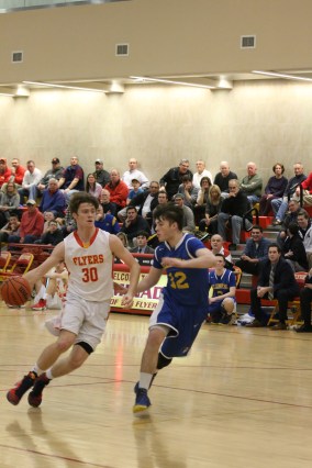 Kyle Murphy ’17 is in mid-dribble while driving into the crease to the net.