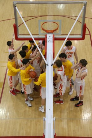 The Chaminade varsity basketball team gets ready to break after huddling under the net.