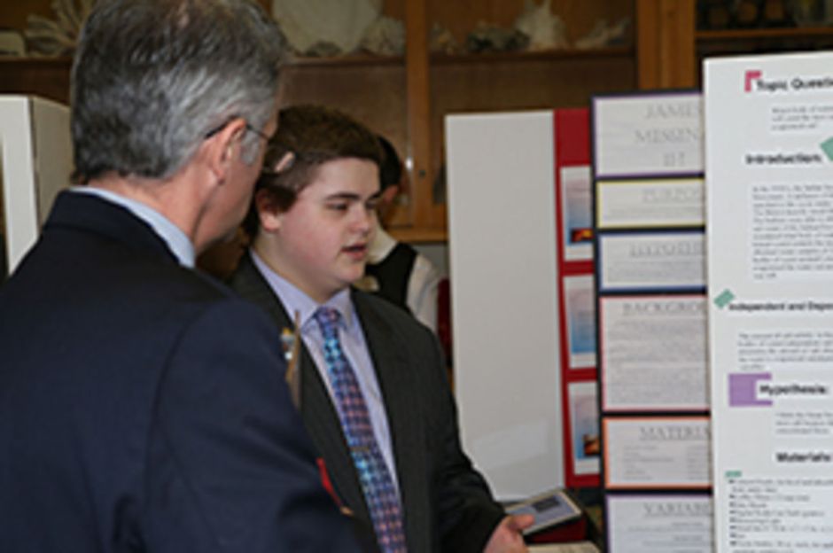 Joseph Moses ’19, winner of the Earth Science division of the science fair, explains the specifics of his project to Mr. Dennis Flood ’89.