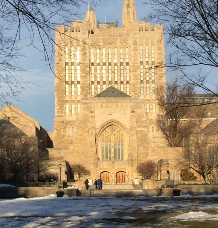 The fields in front of one of Yale’s collegiate gothic buildings is partially covered in melting snow. 