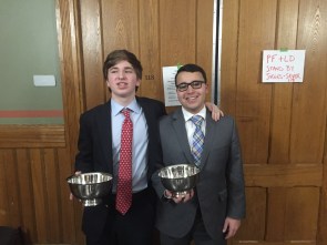 (l.-r.) Aidan Fitzgerald ’18 and John Michael Magliore ’18 present their quarterfinalist awards for JV Lincoln-Douglas debate. 