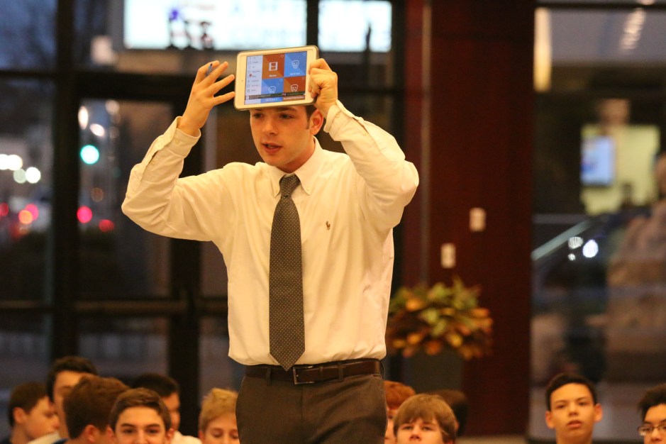 Mr. Patrick Cahill ‘11 participates in a game of “Heads Up” with members of the freshmen class.