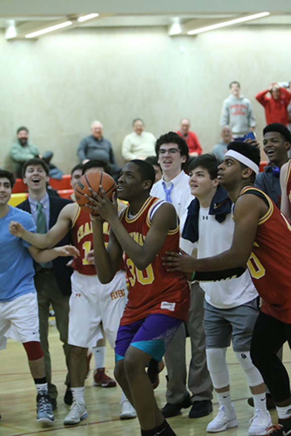Members of the senior class prepare to storm the court while Gilbert Onu ’16 gets ready to take a shot. 
