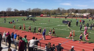 Two Flyers maintain a presence in the main pack of runners in the midst of a competitive race.