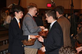Students line up after the prayer service to receive holy cards blessed by Fr. Garrett Long, S.M.,  ’62.