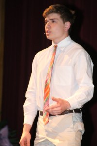 Patrick Johnson ’17, along with fellow members of the drama club, addresses the students.