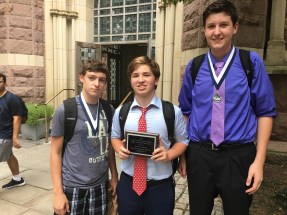 (l.-r.) Tim Franz ’19, Aidan Fitzgerald ’18, and  Sean Lochner ’19 stand with their awards just outside Yale’s famous Battell Chapel.