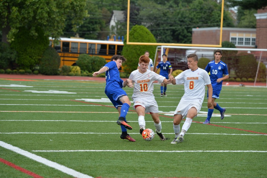 Seniors Tim Davis and Jack Nuttall lunge for a loose ball near midfield in Chaminade’s 5-1 victory over Kellenberg.