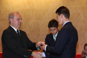 Bro. Joseph Bellizzi, S.M., ’78 hands Colin Fischer ’18 a silver pin for his second straight year on the honor roll.