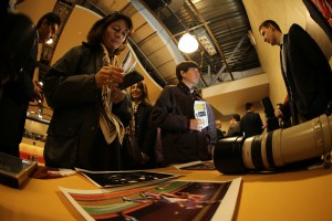 Families crowd around the Photo Service table to learn more about the club.