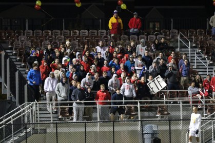 The lively student section collectively stands and cheers as regular time winds down.