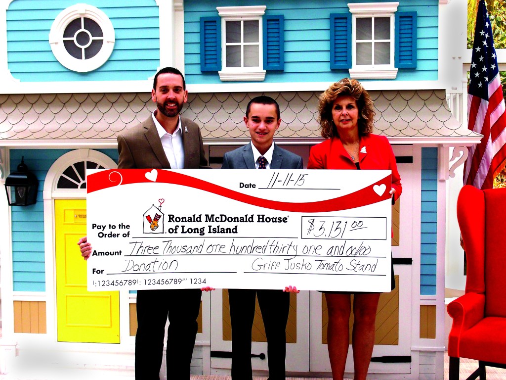 Griffin Jusko ’19 presents his donation to the president of the Ronald McDonald House of Long Island, Matthew Campos, and Volunteer and Program Manager Betti McClellan.