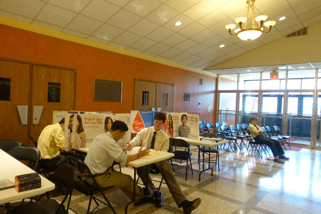 Seniors fill out the proper information as they wait patiently in the lobby before they donate blood.