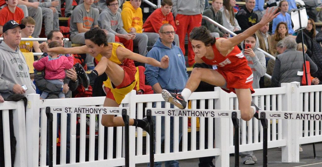 Alex Calderon ‘20 clears his hurdle while neck-and-neck with his opponent.