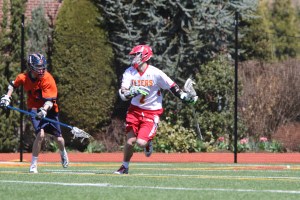 University of Virginia Lacrosse Commit Regan Quinn races past a Manhasset defenseman towards the goal.